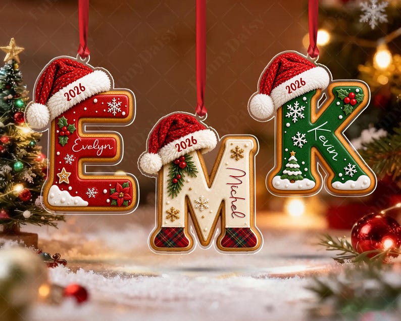Three hanging Christmas ornaments shaped like letters E, M, and K.