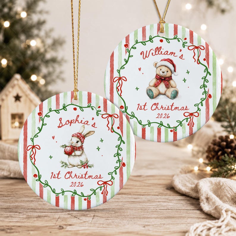 Two round ceramic Christmas ornaments with gold hanging strings. One features a rabbit with a red hat and scarf, the other a teddy bear with a red hat and scarf. Both have red and green stripes, a green wreath, and text.