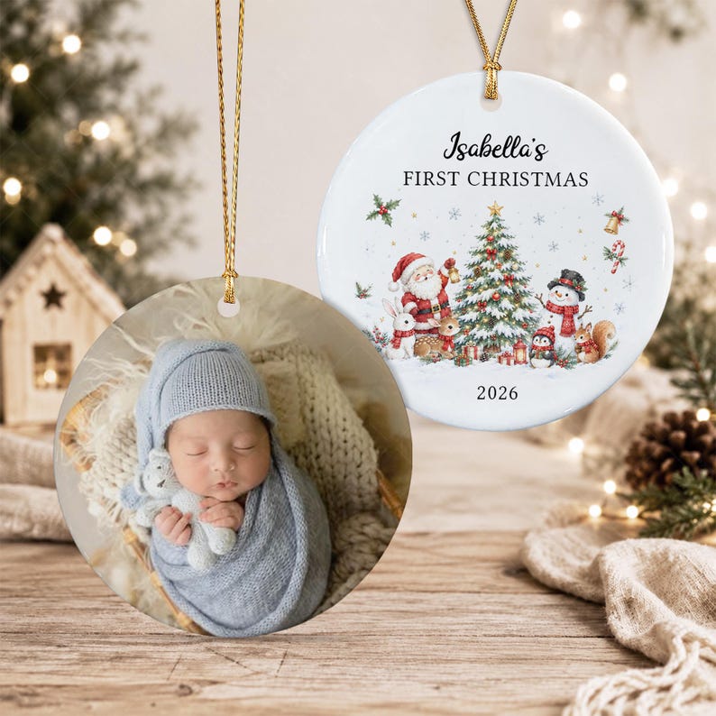 Two round ceramic ornaments with gold hanging cords. One features a photo of a baby in a blue knit hat and blanket holding a toy.