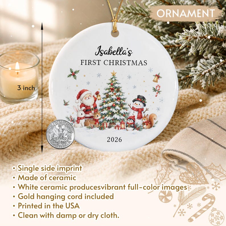 A round white ceramic ornament featuring a colorful illustration of Santa Claus, a snowman, a penguin, and forest animals around a Christmas tree. The text reads Isabella's FIRST CHRISTMAS 2026.