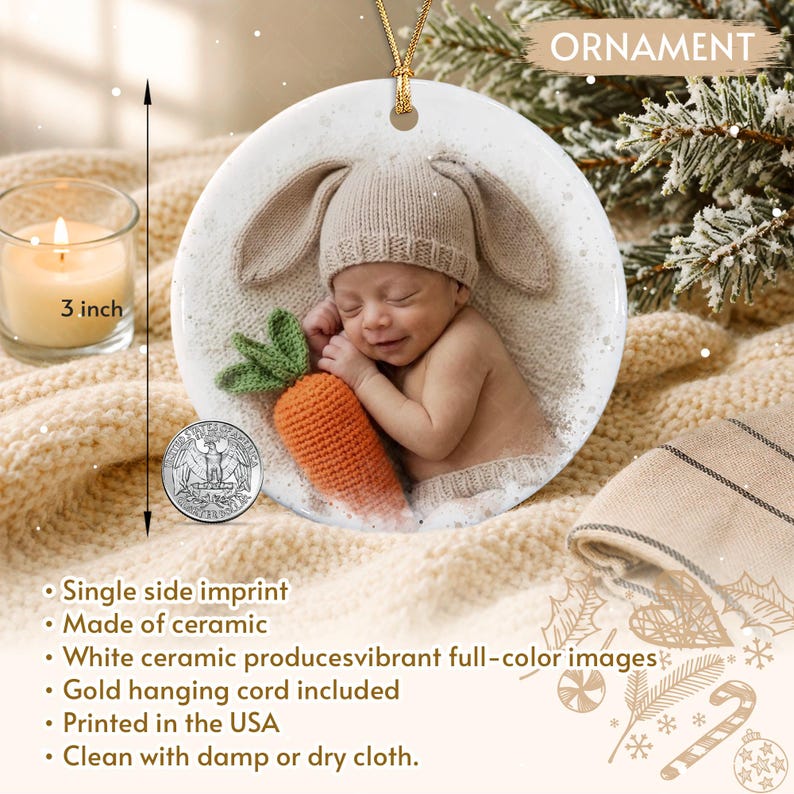A round white ceramic ornament featuring a printed image of a sleeping infant wearing a tan knit bunny hat and holding a crocheted orange carrot with green leaves.