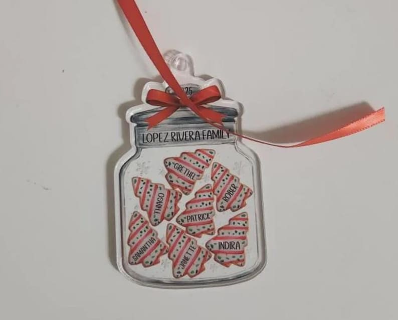 A clear acrylic jar-shaped ornament featuring a red ribbon bow at the top.