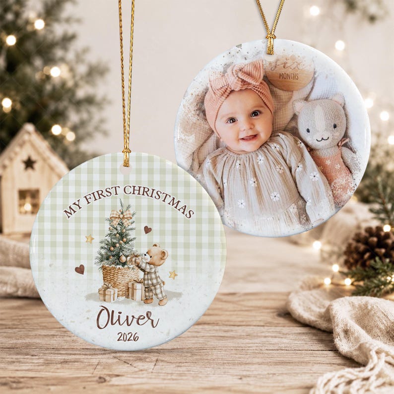 Two round ceramic ornaments with gold hanging strings. One features a photo of a baby wearing a pink headband next to a plush toy.