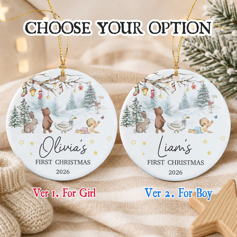 Two round white ceramic Christmas ornaments with gold hanging strings. Each features a winter forest scene with a bear, rabbit, goose, and baby.