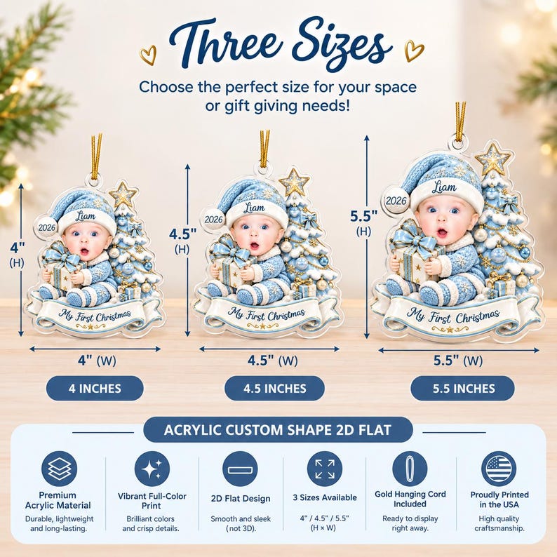 Three flat acrylic Christmas ornaments featuring a baby in a blue hat holding a gift next to a decorated tree. The ornaments are labeled with the name Liam, the year 2026, and the text My First Christmas.