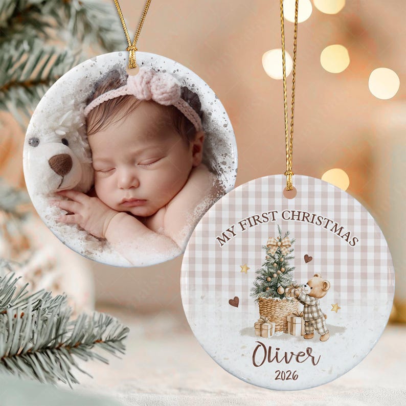 Two round ceramic ornaments with gold hanging strings. One features a photograph of a sleeping infant wearing a pink headband next to a plush toy.