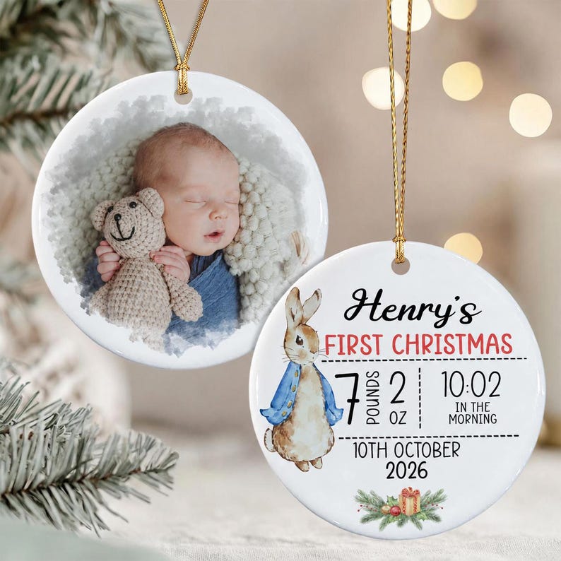Two round white ceramic ornaments with gold hanging strings. One features a photograph of a sleeping baby holding a crochet teddy bear.