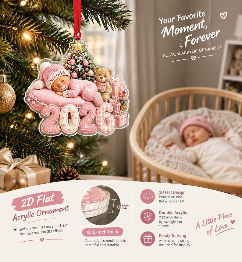 A custom acrylic ornament featuring a sleeping baby in a pink hat and outfit, a teddy bear, a Christmas tree, and the year 2026. The ornament is 0.12 inches thick, flat, and includes a red hanging string for display purposes.