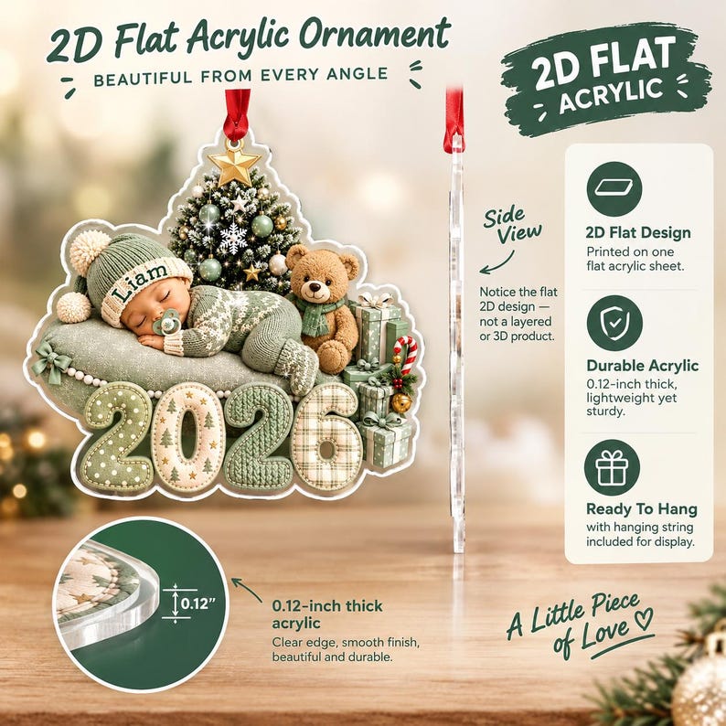 A 2D flat acrylic ornament featuring a sleeping baby in a green knit outfit with the name Liam, a teddy bear, a Christmas tree, and the year 2026.