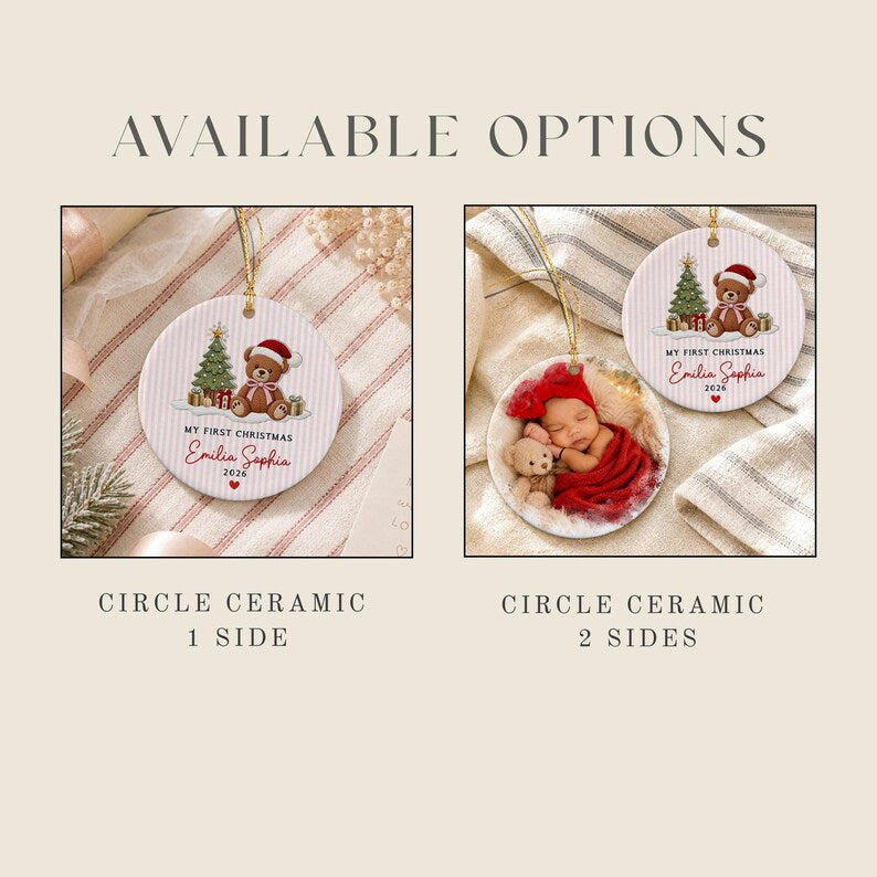 Two round ceramic ornaments with gold hanging strings. One features a teddy bear, Christmas tree, and the text 'MY FIRST CHRISTMAS Emilia Sophia 2026'. The other shows a baby in a red hat with a teddy bear and the same text.