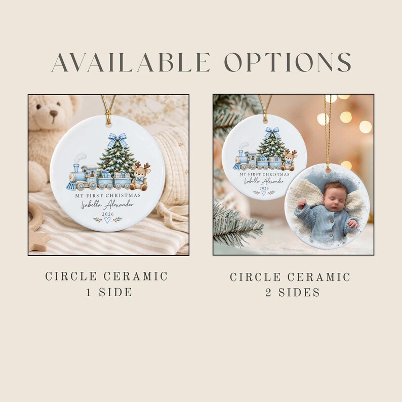 Two white circular ceramic ornaments with gold hanging strings. One shows a blue train, Christmas tree, and reindeer with text 'MY FIRST CHRISTMAS Isabella Alexander 2026'. The other shows the same design plus a photo of a baby.