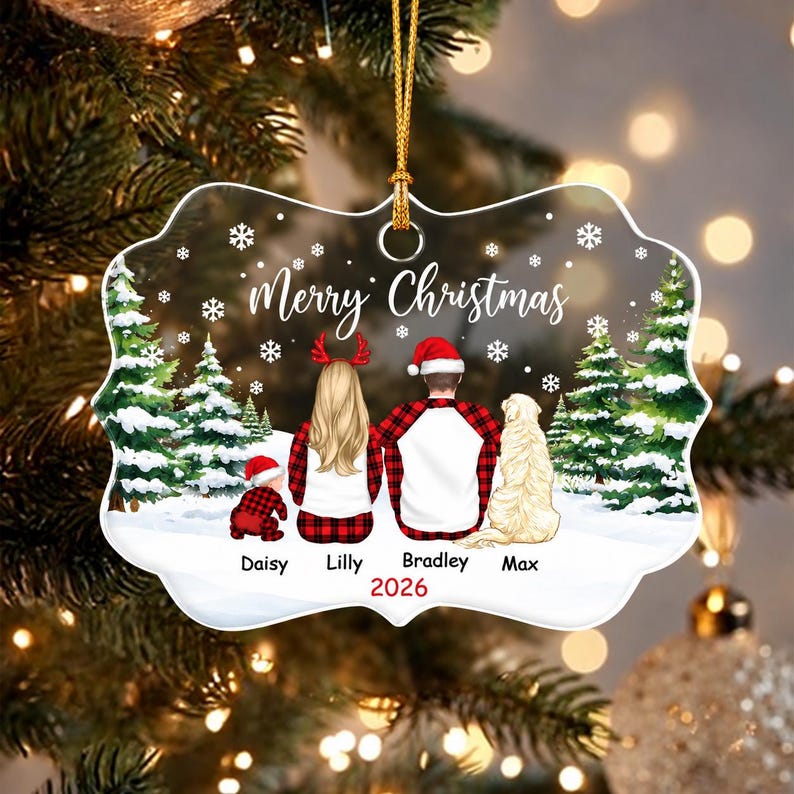 A clear, scalloped-edge Christmas ornament featuring a printed illustration of a family and dog in a snowy forest. The text reads Merry Christmas and 2026, with the names Daisy, Lilly, Bradley, and Max printed below the figures.