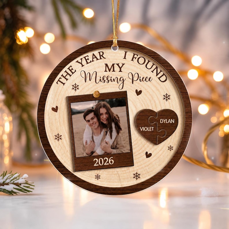 A round wooden Christmas ornament featuring a light wood grain center and a dark wood border.
